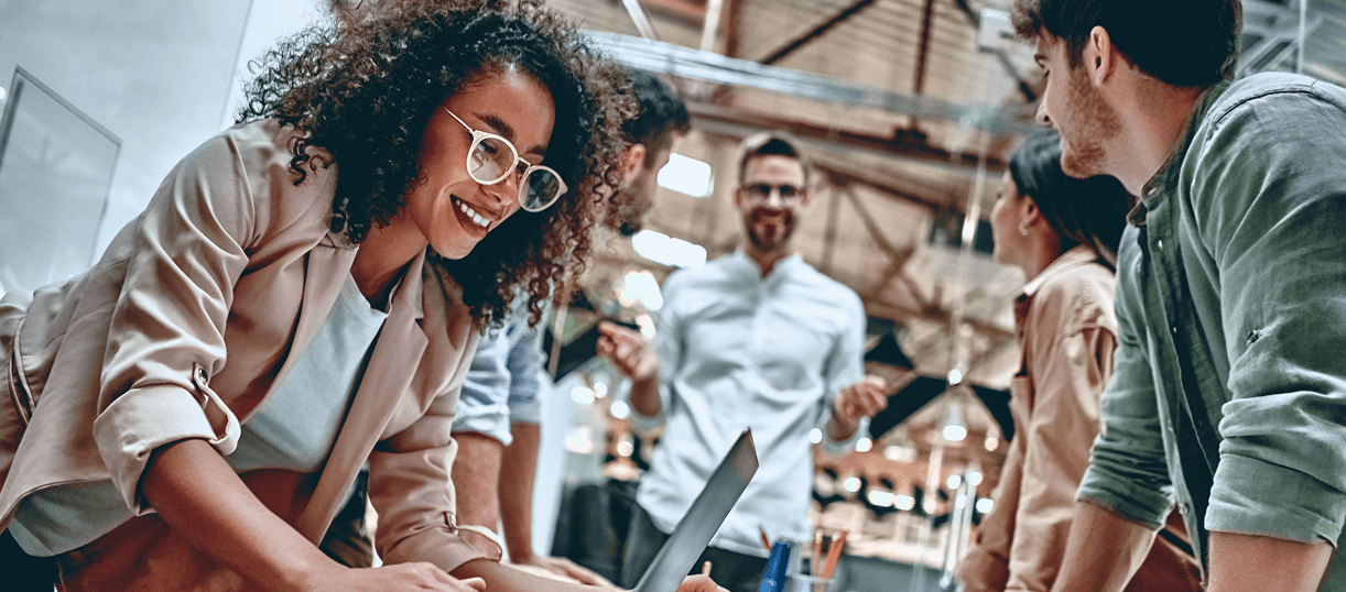 Professionals collaborating around a shared workspace